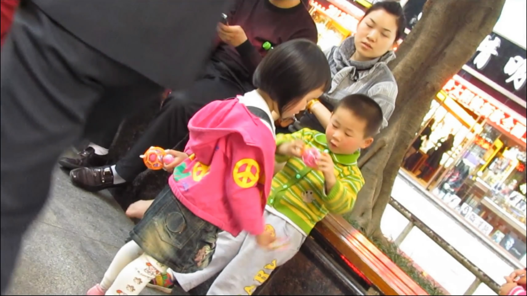 Lady crossed her nylon feets while in the park with her family